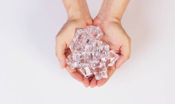 istock Hands is holdine Ice cubes isolated on white background. 2151592565
