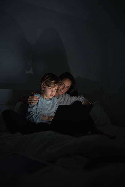 istock Woman helping son to do homework on laptop 2151594873