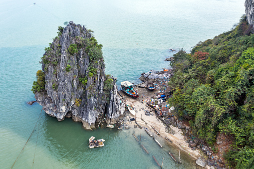 Fishing boat stranded on an islet in Halong Bay, Vietnam