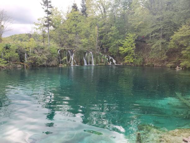 istock Blue lake with small waterfalls 2151600023