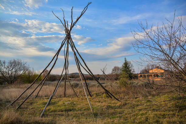 A hand made teepee structure is made from fallen trees and branches.  It is in a flat, dry, treed area of the Lethbridge River Bottom by the Oldman River.  When the river is hit, this area is a floodplain, and will be filled with water. Southern Alberta.