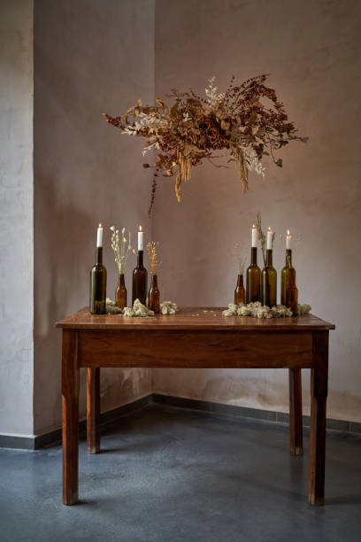 istock Decor of table with bottles on and flowers above 2151603651