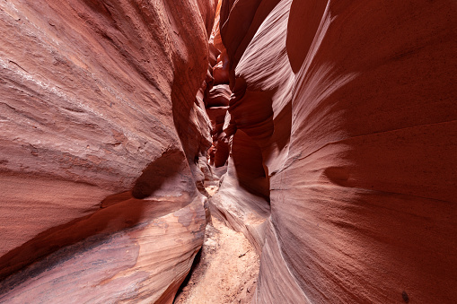 Antelope slot canyon near Page Arizona highlights the narrow passageway and amazing, glowing light and intricate patterns that form over millions of years from the combination of water and sediment flow.