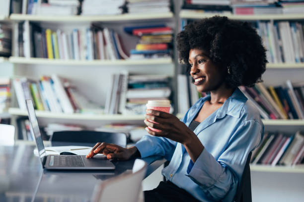 istock African American Woman Enjoying Coffee While Working on Laptop 2151609614
