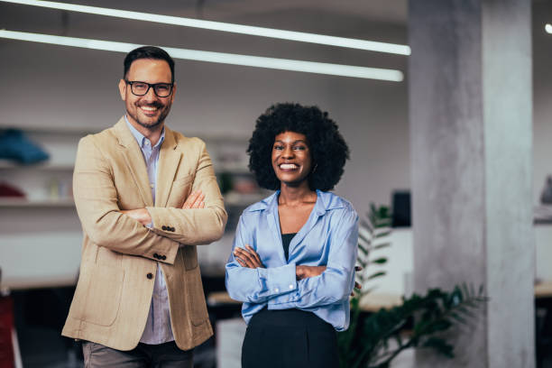 Confident Business Professionals Smiling in Modern Office