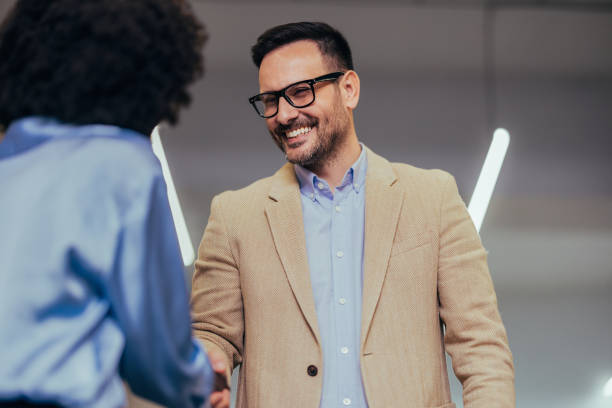 istock Business Professionals Shaking Hands in Modern Office 2151609676