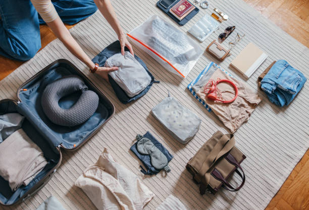 Unrecognizable Woman Packing A Suitcase At Home