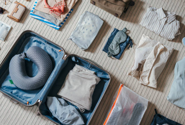 istock Top View Of An Open Suitcase With Clothes On The Floor 2151612473