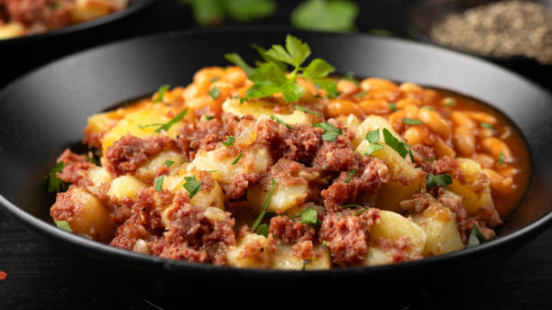 istock Corned beef hash with potatoes and beans in tomato sauce. 2151614389