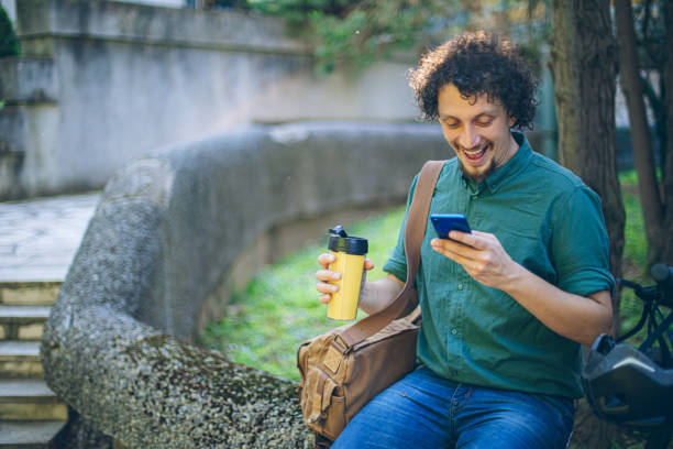 istock Young business man having a coffee on his way to work with e-scooter 2151616112