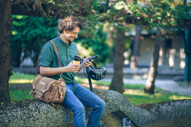 istock Young business man having a coffee on his way to work with e-scooter 2151618151