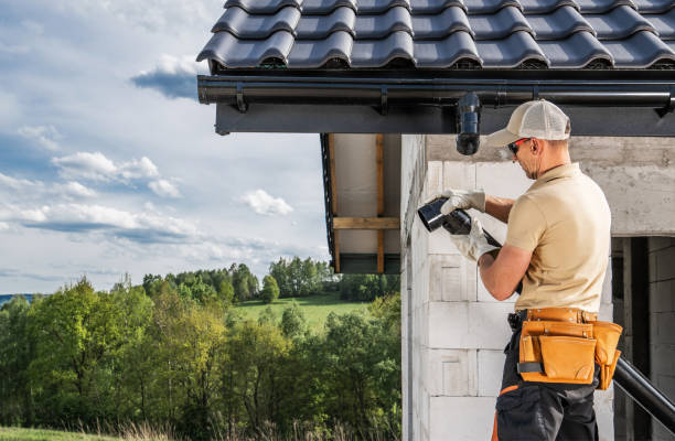 istock Construction Contractor Roof Worker Installing House Gutters 2151619726