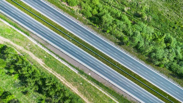 istock Aerial View of Highway Cutting Through Forest 2151622562