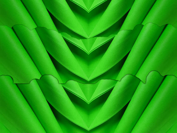 beautiful non-woven fabric roll in green color. stack of folded polypropylene fabric.