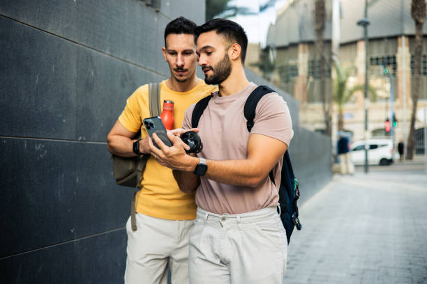 Happy gay couple enjoying a walk during their vacation in Valencia.