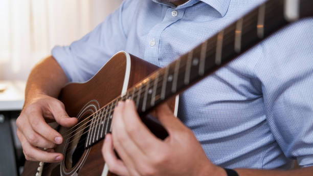 istock Guitar lesson instrument training man hands chords 2151624979