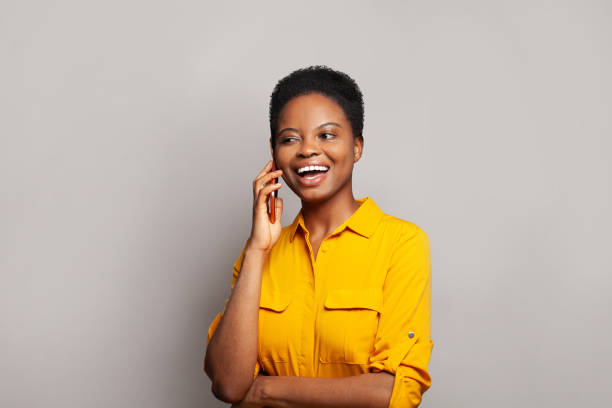 istock Attractive woman talking by phone on grey banner background 2151625015