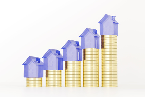Blue glass houses standing on the coins stacks. Real estate investment concept. Growth chart. Real estate business illustration. House cost. 3d rendering.