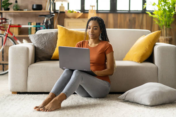 istock A rating student is sitting on ground and learning 2151625294