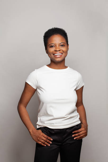 istock Happy woman wearing white empty t-shirt standing on grey studio wall background 2151625296