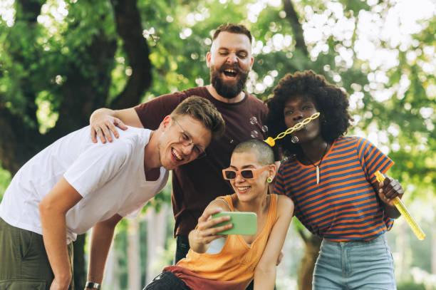 istock Young interracial cheerful students taking slefies in nature. 2151625344