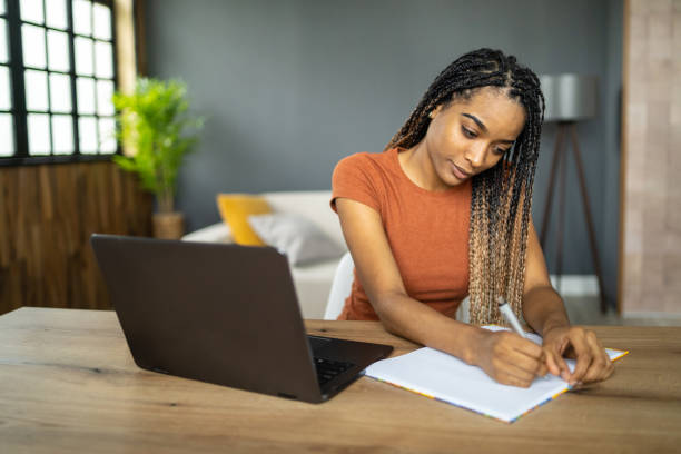 istock A young latin girl is writing in her notepad 2151625359