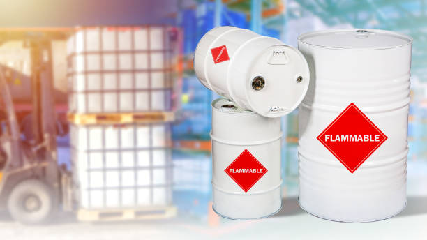 istock Flammable products warehouse. Inscription is flammable on white barrels. Concept - backup storage of petroleum products. State reserve of oil. Barrels in the background of the warehouse. 2151627126