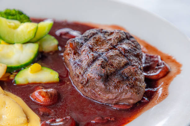 gourmet ham steak with vegetables, carrot,  potatoe and  brussels sprout