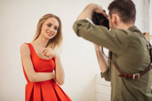 istock lovely model poses for a photographer at a studio 2151629861