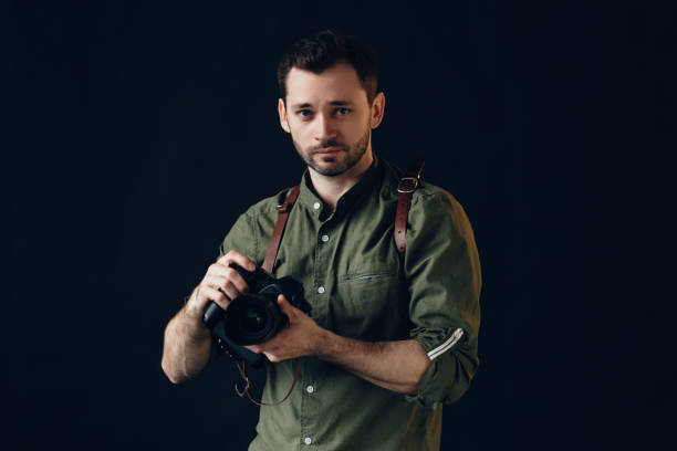 istock young handsome talented photographer looking at the camera 2151629888