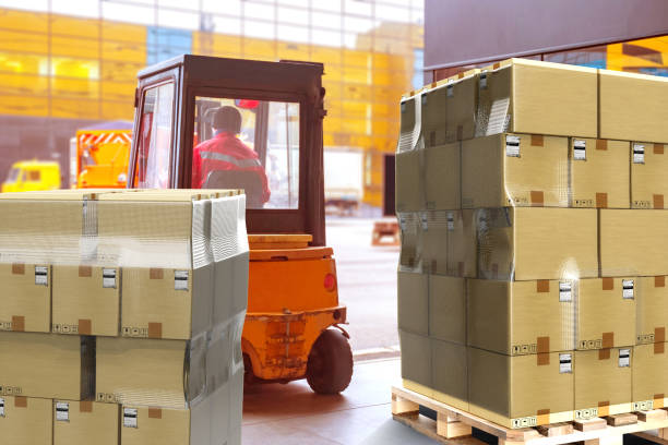 istock Warehouse center. Pallets with boxes in building. Forklift inside storage hangar. Cardboard parcels on boxes. Warehouse area. Forklift is loading. Delivery service warehouse. Logistics processes 2151630056