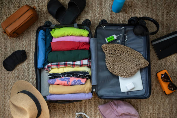 istock Suitcase being prepared with clothes and travel items before a summer vacation 2151634617