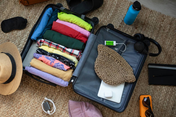 istock Suitcase being prepared with clothes and travel items before a summer vacation 2151634713