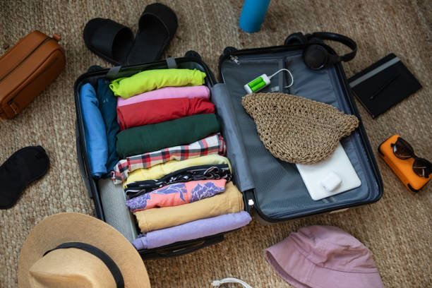 istock Suitcase being prepared with clothes and travel items before a summer vacation 2151634725