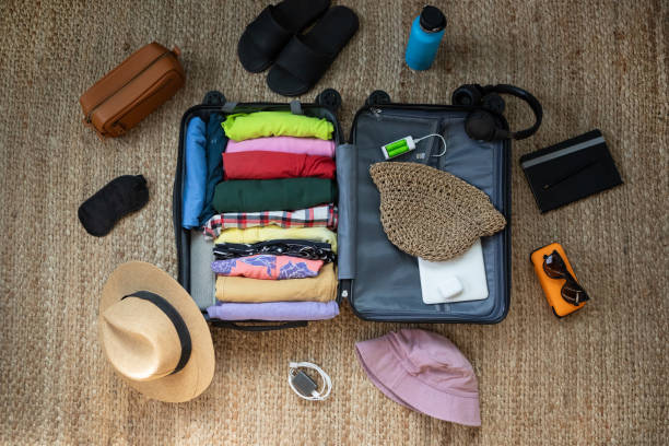 istock Suitcase being prepared with clothes and travel items before a summer vacation 2151634787