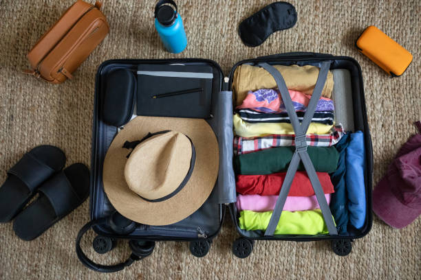 istock Suitcase being prepared with clothes and travel items before a summer vacation 2151634905