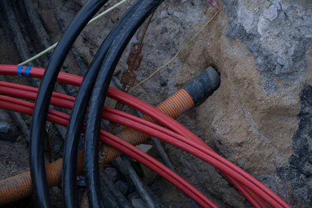 istock Construction site with electric cables are buried underground, infrastructure installation, lot of communication Cables on street 2151637022