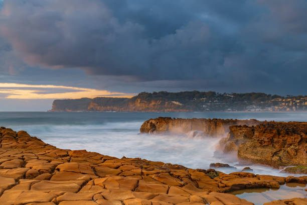 istock Sunrise, sea, waves, clouds and tessellated rock platform 2151638181