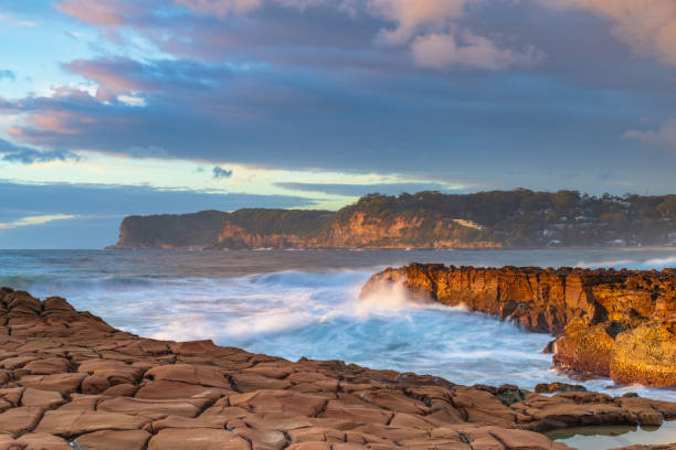 istock Sunrise, sea, waves, clouds and tessellated rock platform 2151638189