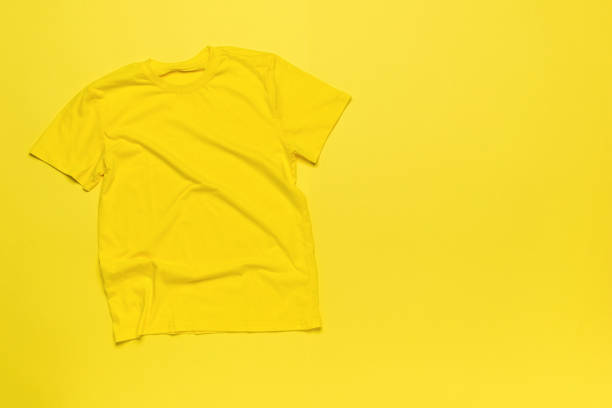 istock A simple yellow T-shirt on a yellow background. 2151639576