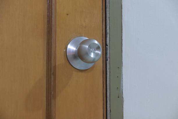 istock Silver round door handle on wooden door 2151646274