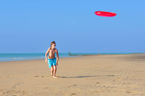 istock Kids playing on beach. Children play at sea. 2151646878