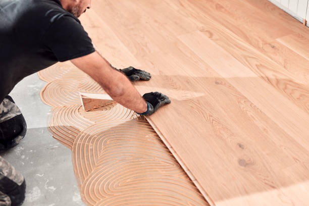 istock Professional handyman installing laminate flooring in a new apartment. 2151652825