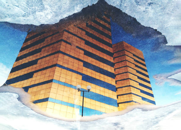 Sepia image of high buildings reflecting on the puddle