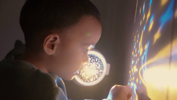 istock Baby boy playing projection light in bedroom 2151655823