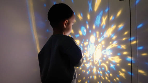 istock Baby boy playing projection light in bedroom 2151655825