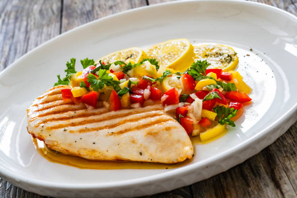 istock Grilled chicken breast and fresh vegetables on wooden table 2151657118