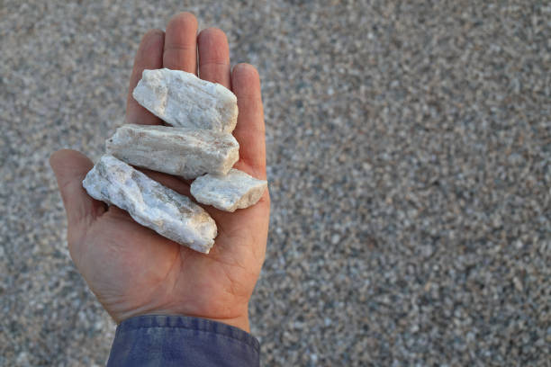 istock Spodumene pegmatite ore held in hand. Commercially viable source of Lithium (Li) used in lithium-ion batteries for electric cars and mobile devices. 2151657795