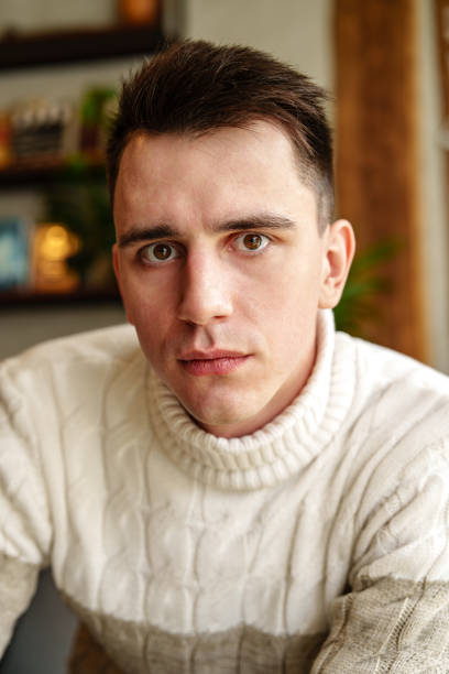 istock Man in White Sweater Looking at Camera 2151658377