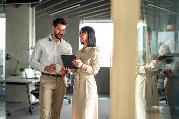 istock Caucasian Business Executives Discussing Over Tablet in Office 2151658507
